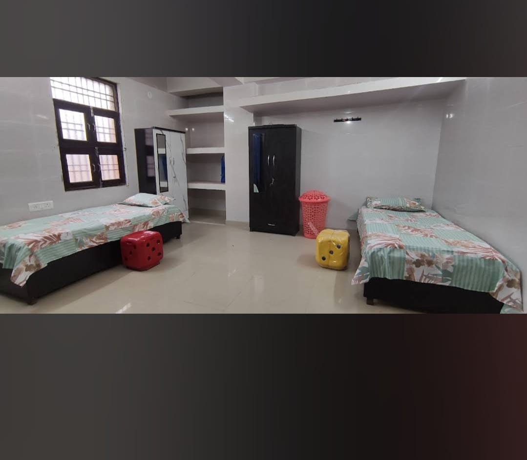 Clean furnished Shanvi Girls PG room with beds and storage